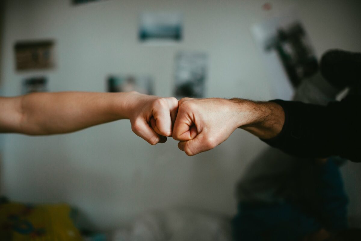 two persons fist bumping