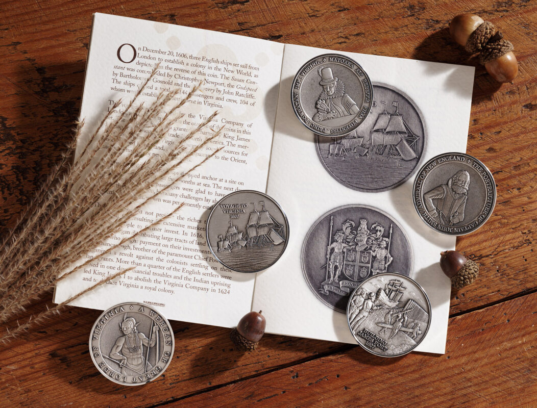 several commemorative coins laying flat on a wooden table